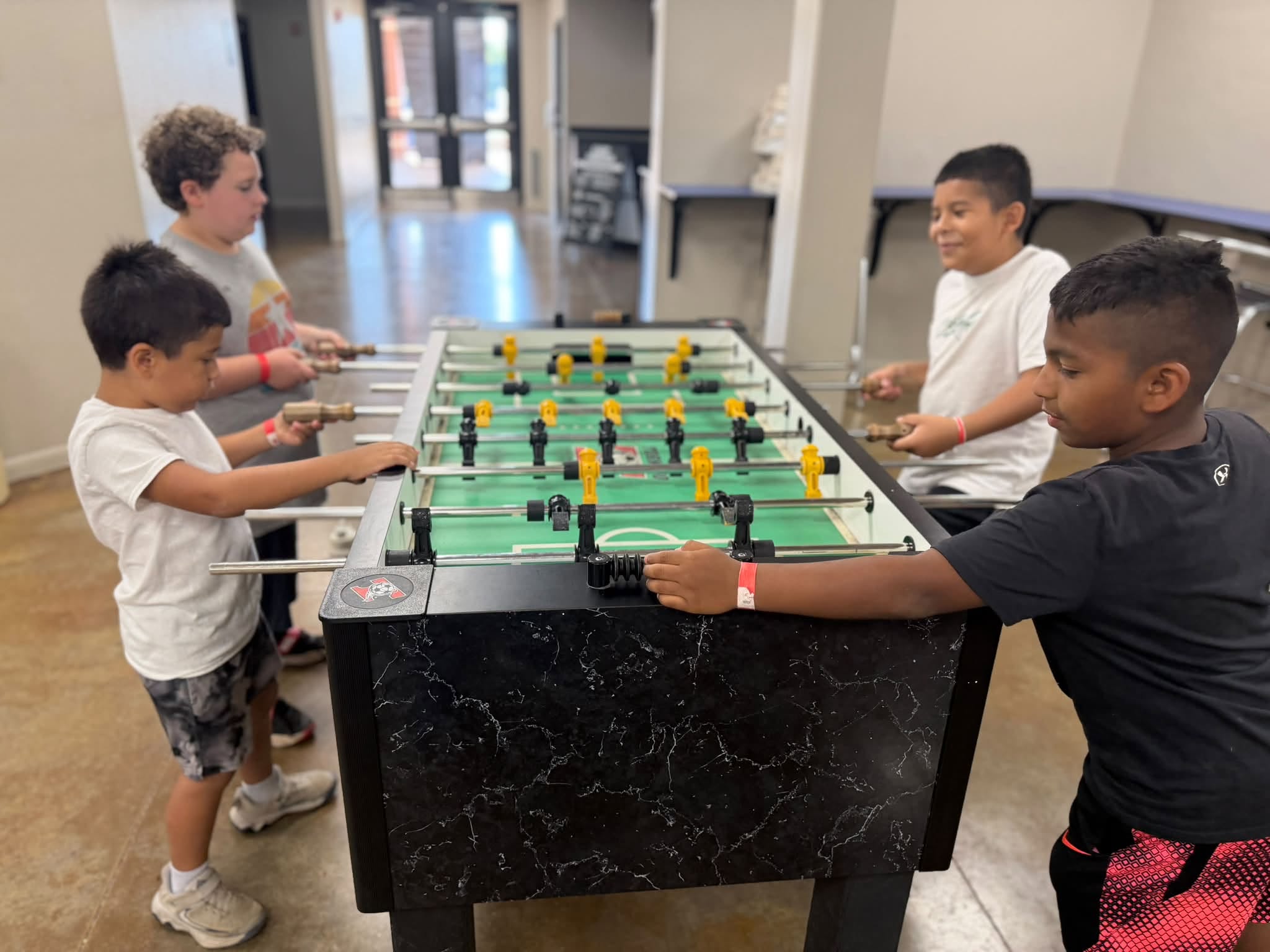 Boys playing foosball together